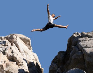 boy jumping over the mountains
